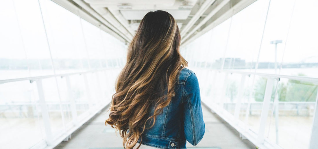 Woman with big bouncy TYME curls and highlights