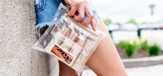 Woman holding traveler kit in jean shorts