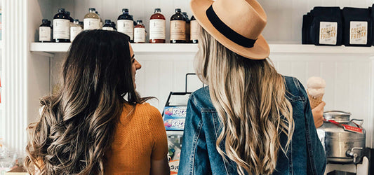 woman in candy shop with hat and curls