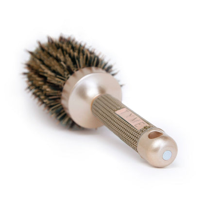 End of handle on TYME 3-inch Round Hair Brush showing hole for hook storage and magnet for alternative storage.