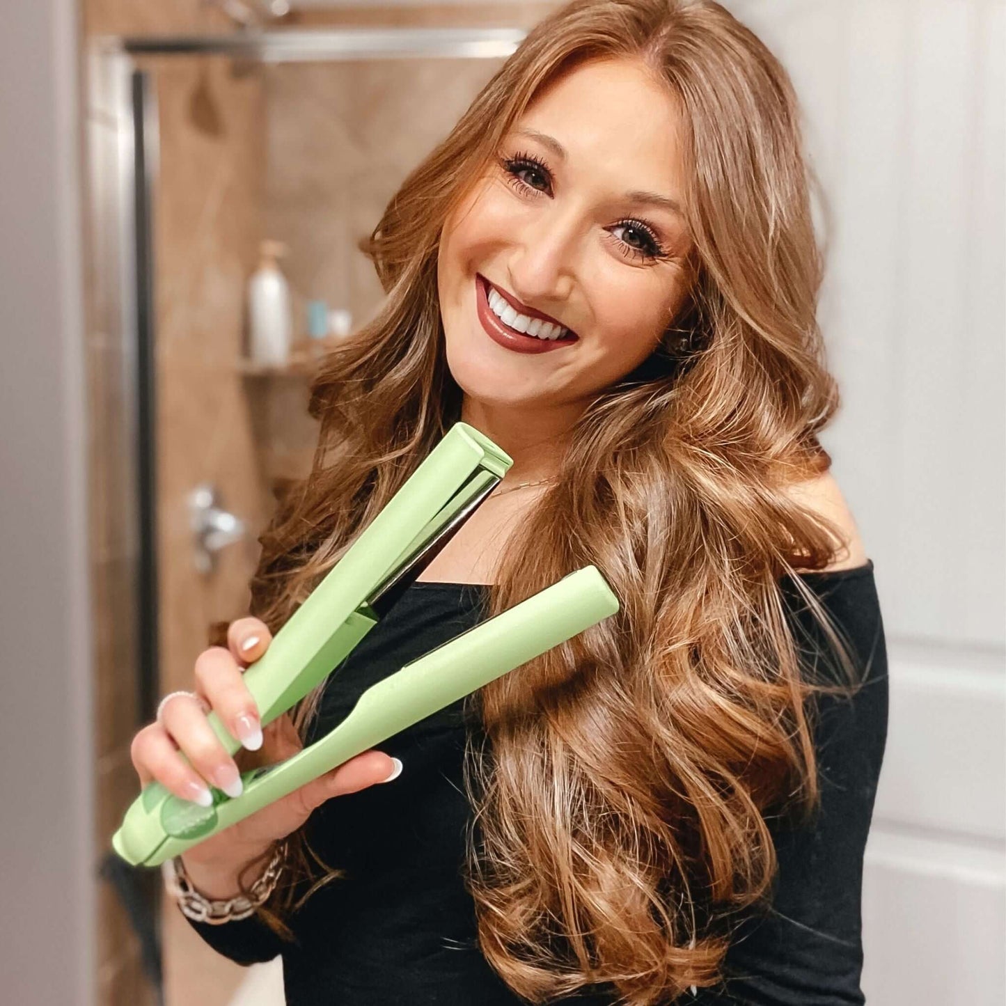 Woman with strawberry blonde hair using the TYME Iron Pro: Limelight.