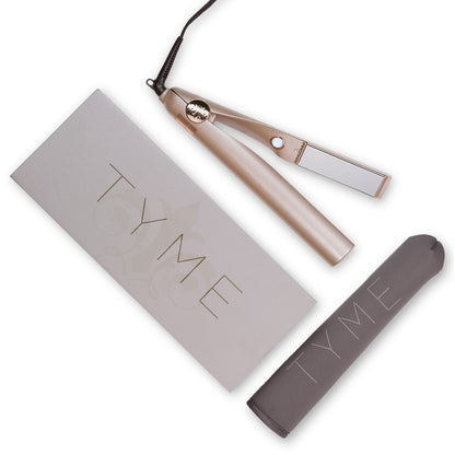 Champagne pink metallic TYME Iron Pro with rose gold details next to the included Heat Sleeve with logo and product box.