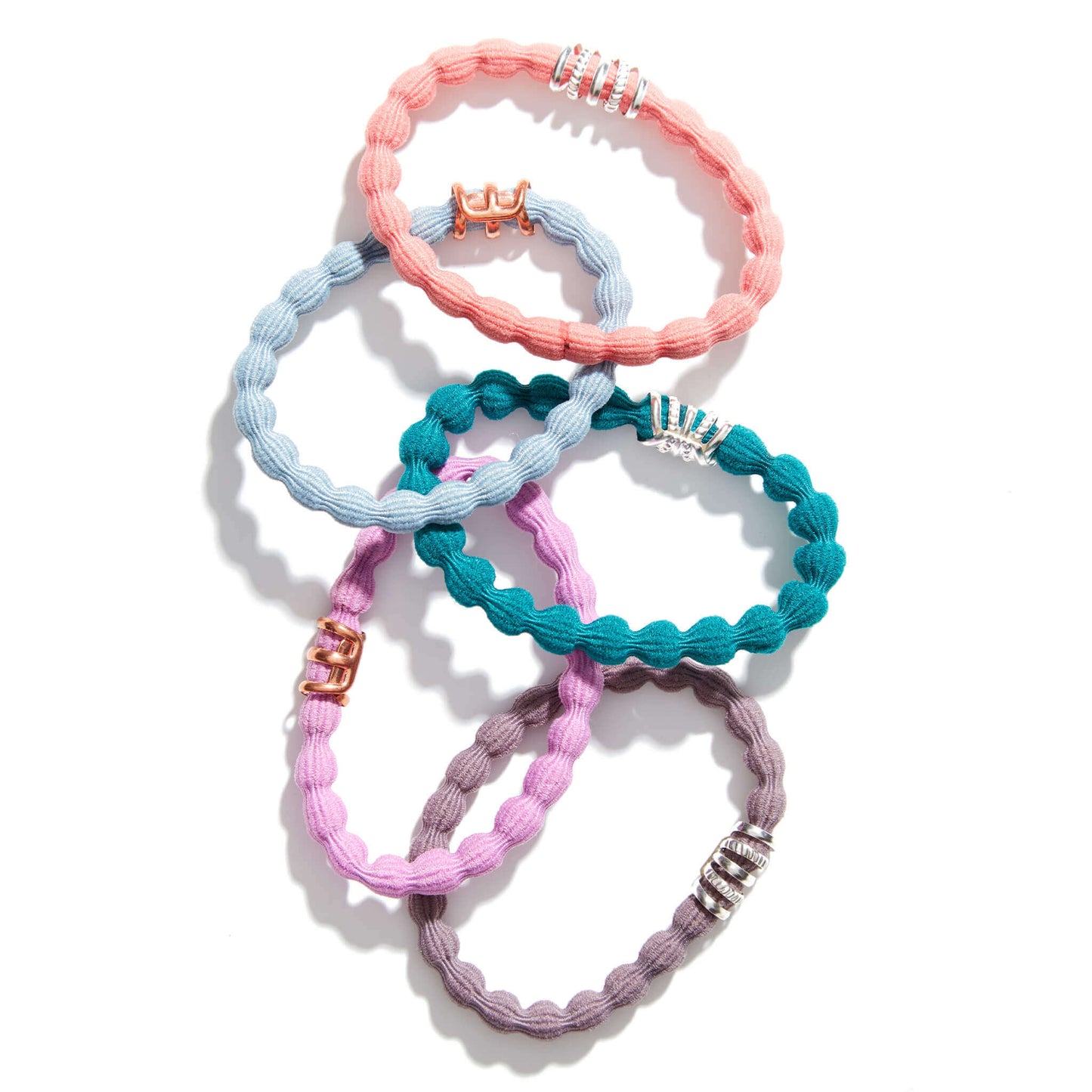 five uplift bands hair twistie ties in peach, baby blue, teal, periwinkle purple, and taupe neutral